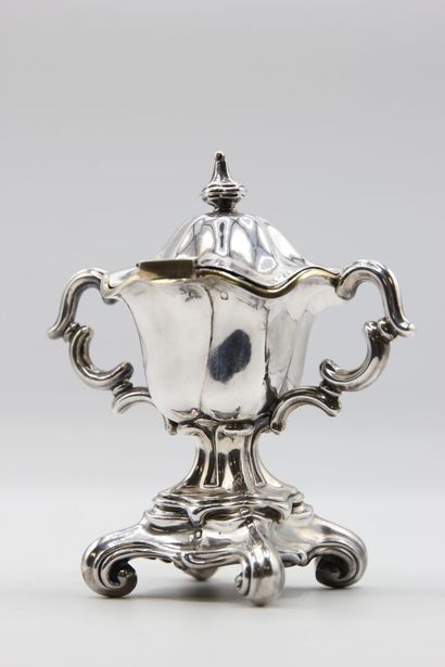 Mustard pot in silver resting on a quadripod...