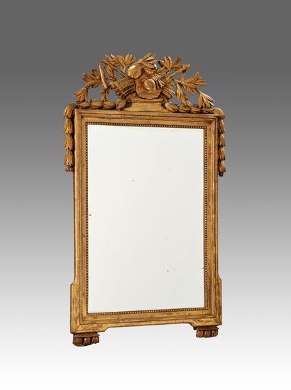 Mirror in gilded and carved wood decorated...