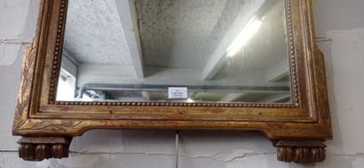 Mirror in gilded and carved wood decorated...