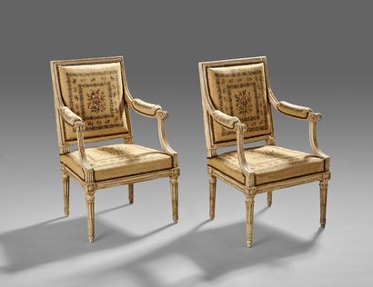 Pair of carved and white lacquered wood armchairs...