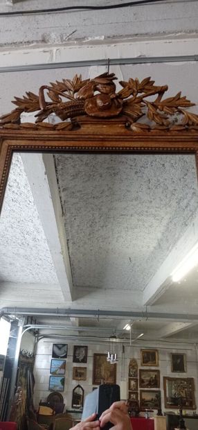 Mirror in gilded and carved wood decorated...