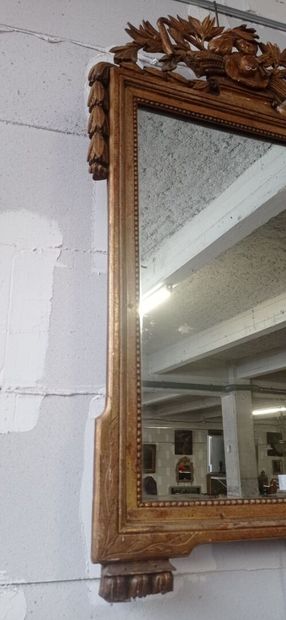 Mirror in gilded and carved wood decorated...