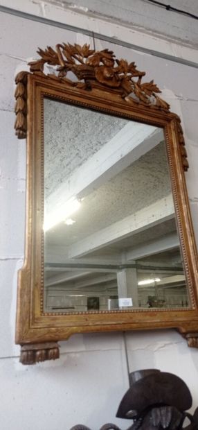 Mirror in gilded and carved wood decorated...