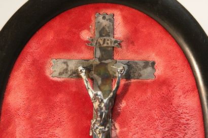Christ on the cross in silver.

On a red...