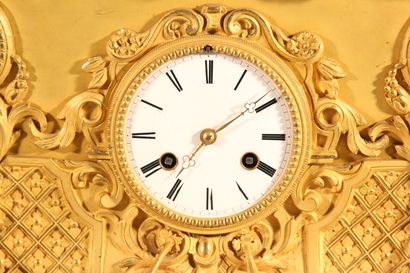 Clock in gilded and chased bronze.

The upper...