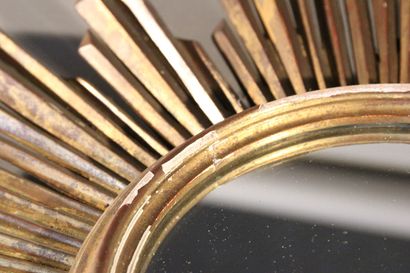 Large gilded and carved wood sun mirror.

The...