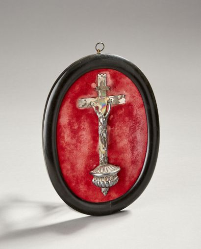 Christ on the cross in silver.

On a red...