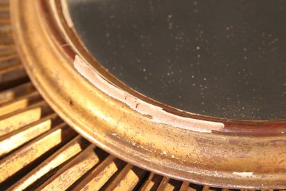 Large gilded and carved wood sun mirror.

The...