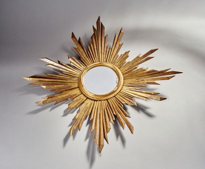 Large gilded and carved wood sun mirror.

The...