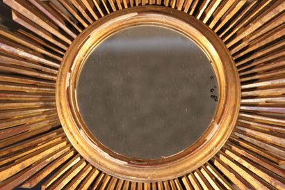 Large gilded and carved wood sun mirror.

The...