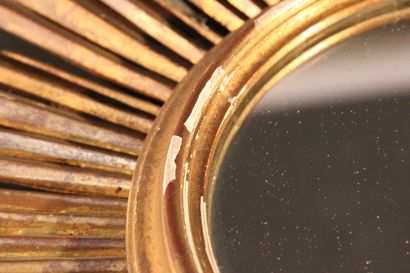 Large gilded and carved wood sun mirror.

The...
