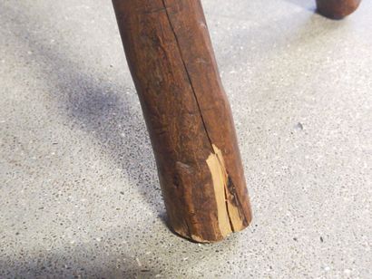 Brutalist chair in natural wood resting on...