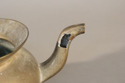 Bronze pitcher with two spouts and a mobile...