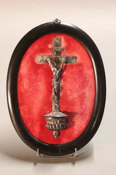 Christ on the cross in silver.

On a red...