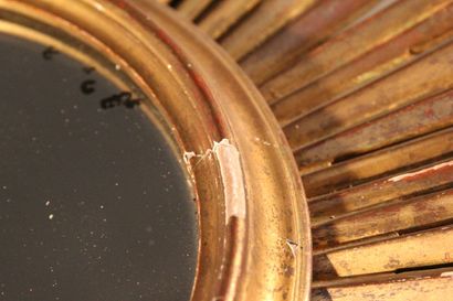 Large gilded and carved wood sun mirror.

The...
