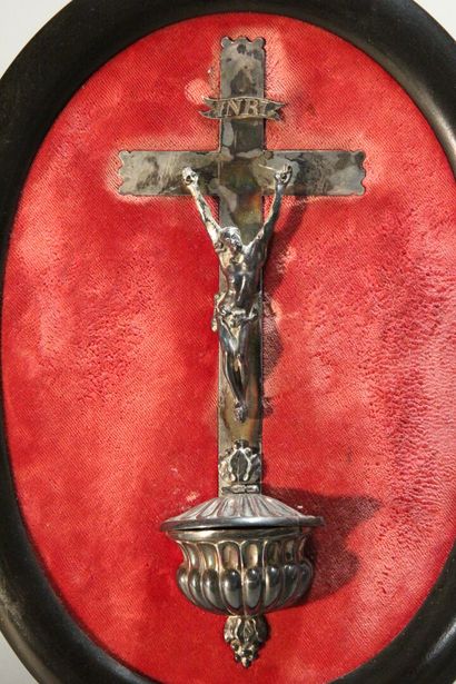 Christ on the cross in silver.

On a red...