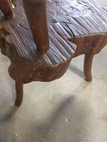 Brutalist chair in natural wood resting on...