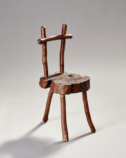 Brutalist chair in natural wood resting on...