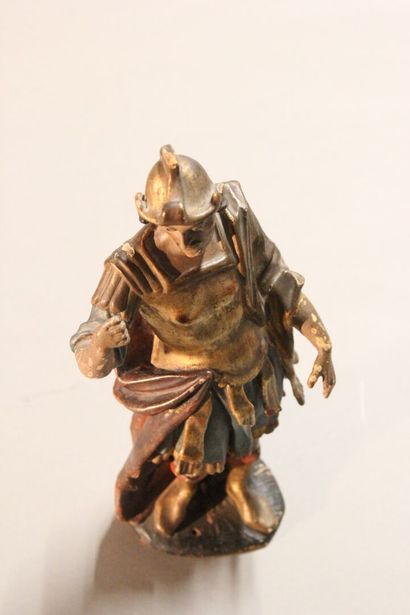 Antique soldier in armor.

Subject in polychromed...
