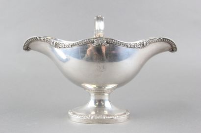 Sauceboat in silver on its polylobed display.

Decorated...