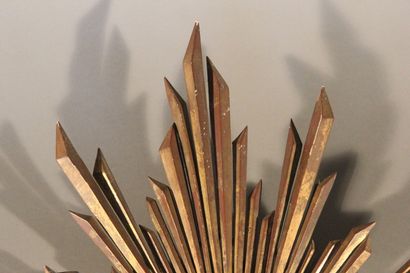 Large gilded and carved wood sun mirror.

The...
