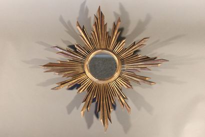 Large gilded and carved wood sun mirror.

The...
