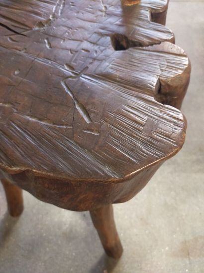 Brutalist chair in natural wood resting on...