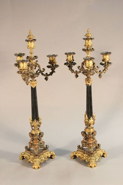 Pair of bronze and black marble candlesticks...
