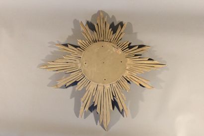 Large gilded and carved wood sun mirror.

The...