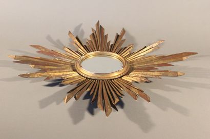 Large gilded and carved wood sun mirror.

The...