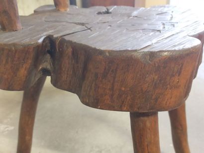 Brutalist chair in natural wood resting on...