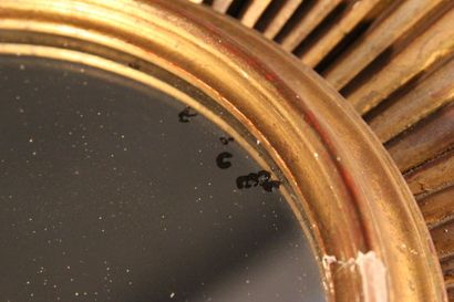 Large gilded and carved wood sun mirror.

The...