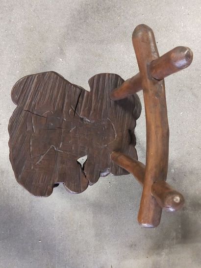 Brutalist chair in natural wood resting on...