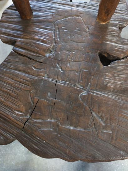 Brutalist chair in natural wood resting on...