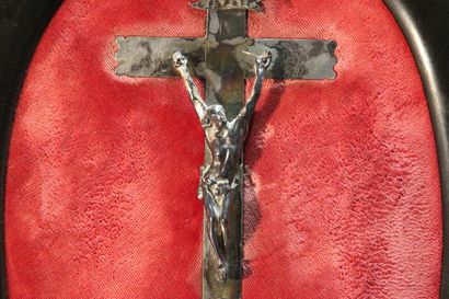 Christ on the cross in silver.

On a red...