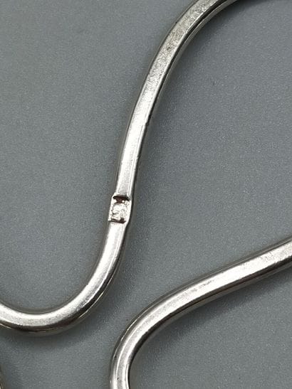 Pair of trivets. Silver bottle of form quarte-feuilles....