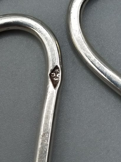 Pair of trivets. Silver bottle of form quarte-feuilles....