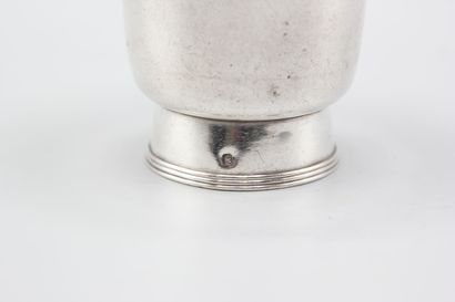 CHRISTOFLE
Silver tumbler resting on a large...