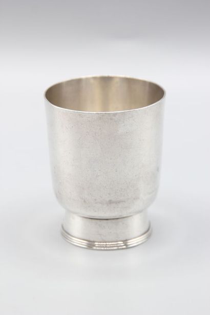 CHRISTOFLE
Silver tumbler resting on a large...