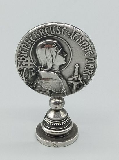 Silver seal representing Joan of Arc in armor...