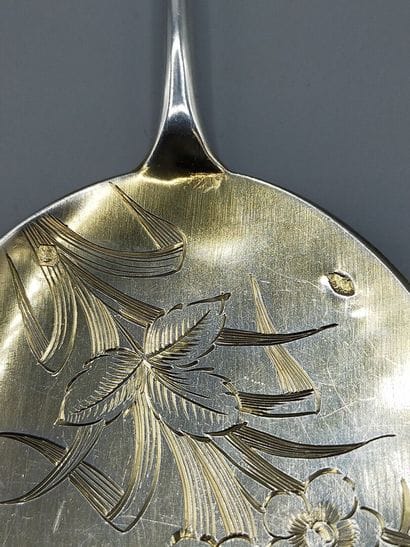 Silver serving ice-cream scoop with a vermeil...