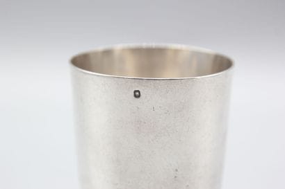 CHRISTOFLE
Silver tumbler resting on a large...