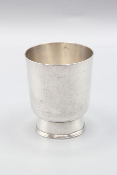 CHRISTOFLE
Silver tumbler resting on a large...