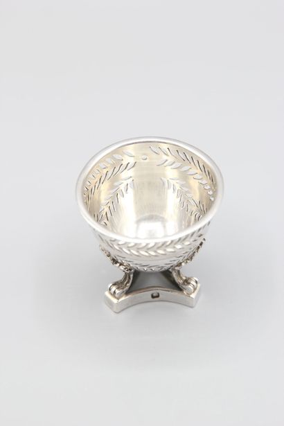 Silver egg cup with three clawed feet with...