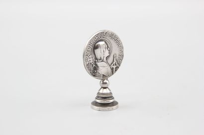 Silver seal representing Joan of Arc in armor...