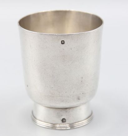 CHRISTOFLE
Silver tumbler resting on a large...