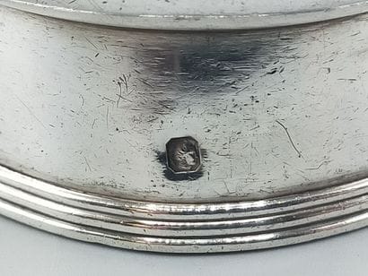 CHRISTOFLE
Silver tumbler resting on a large...