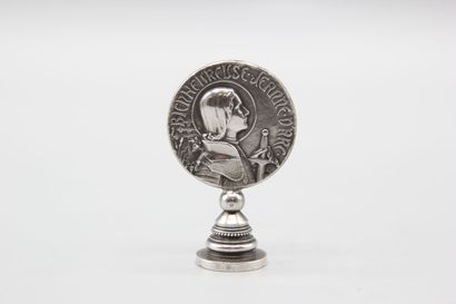 Silver seal representing Joan of Arc in armor...