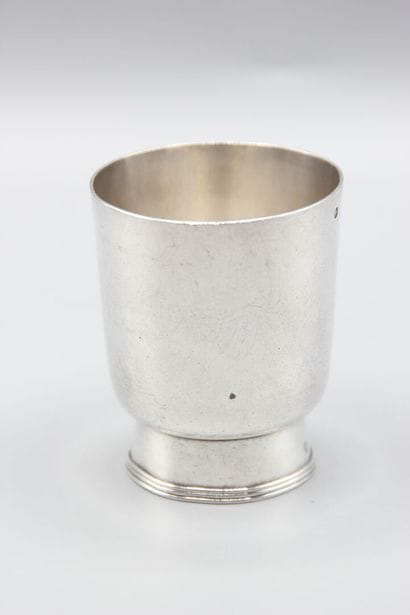 CHRISTOFLE
Silver tumbler resting on a large...