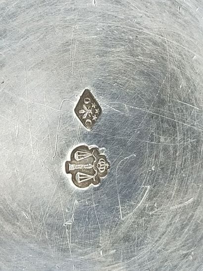 CHRISTOFLE
Silver tumbler resting on a large...